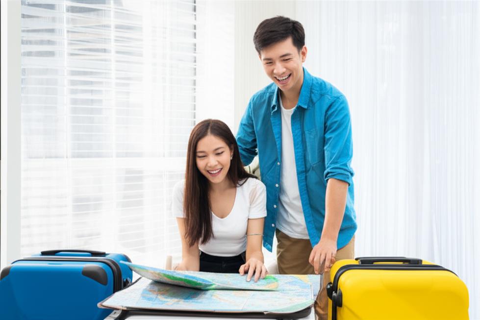 Couple planning Japan trip, browsing a map.